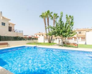 a large swimming pool in front of a building at Arco Mediterráneo chalet independiente in Torrevieja