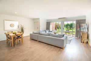 a living room with a couch and a table at Merimbula Holiday Properties in Merimbula