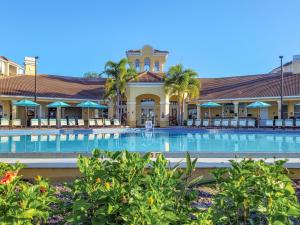 a swimming pool in front of a resort at 4Br 2Bath Condo Balcony 5min Conv Center 2020ft in Orlando