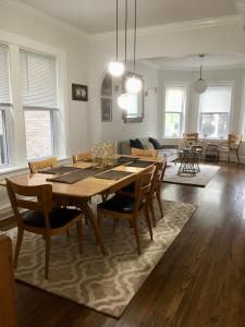 a dining room and living room with a table and chairs at Logan Square Modern Apartment in Chicago
