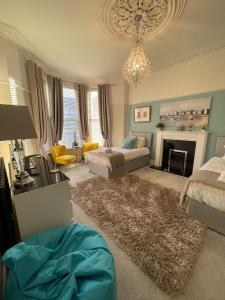 a living room with a bed and a chandelier at Luxury Accomodation close to city centre in Plymouth