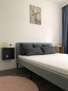 a bed sitting in a room with avertisement at Quattro Casa in Sopron