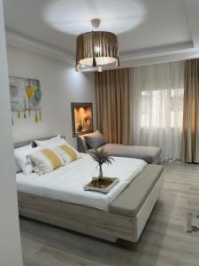a bedroom with a large bed and a couch at Studio SvEt in ParC Mohammedia in Mohammedia