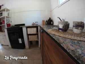 een keuken met een fornuis en een aanrechtblad bij La ponferrada in Villa Ventana