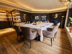 a dining room with a long table and chairs at Sofitel Legend The Grand Amsterdam in Amsterdam