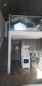 a kitchen with white appliances and a staircase at Best Western Plus Prince George in Prince George