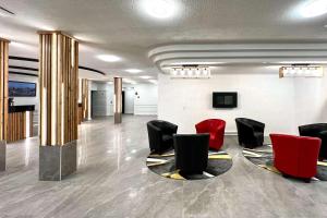 a lobby with red and black chairs in a building at The Vic, Ascend Hotel Collection in Victoria