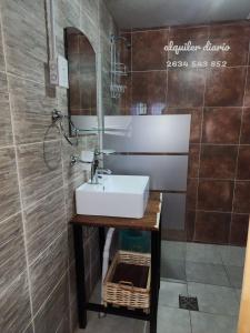 a bathroom with a sink and a mirror at La margarita in Potrerillos