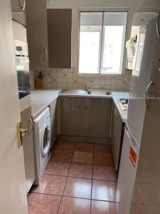 a kitchen with a sink and a washing machine at 018- Premium location Regent Park Radley house in London