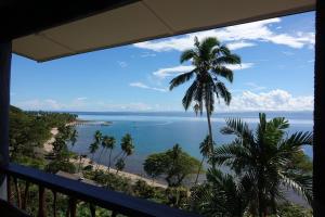 a view of the ocean from a balcony at Beachfront Villa - House of Bamboo, Infinity Pool in Savusavu