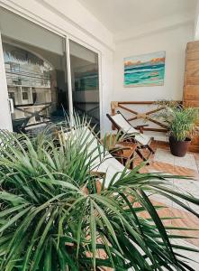 a room with potted plants on a patio at Hotel Nicte Ha Tulum in Tulum