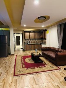 sala de estar con sofá de cuero y alfombra en Galiyaat View By Al Fateh Hotel, en Murree