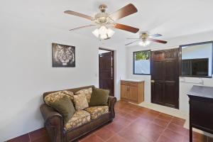 a living room with a couch and a ceiling fan at Playa Potrero - beachfront Villa, big private pool - Casa Bella Catalina in Potrero