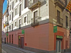 a building on a street in a city at Hostal Radio Barcelona in Barcelona