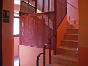 a staircase in a building with a metal railing at Hostal Radio Barcelona in Barcelona