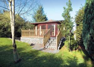 a small house with a porch and a deck at Pound Farm Lodges in Crook