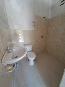 a bathroom with a white toilet and a sink at Mar Rosa Galerazamba Hostal in Galerazamba