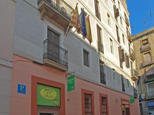 a building with two flags on the side of it at Hostal Radio Barcelona in Barcelona