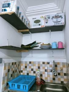 a kitchen counter with a sink and a stove at Globe-trotter vision C in Cotonou