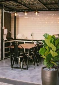 a table and chairs in a room with a kitchen at The Luxury Villa -Private Pool- in Pantai Cenang