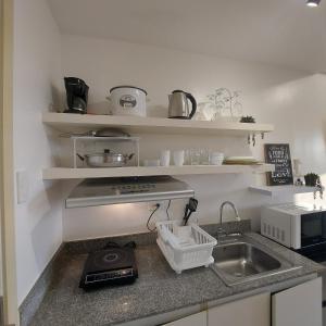 a kitchen with a sink and a counter top at 1BR Condo Unit by Nartleb Staycation in Manila