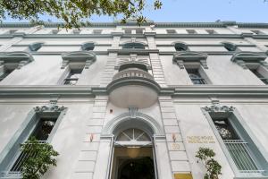 a white building with windows and a balcony at The Pacific House in Sydney