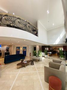 a lobby with couches and a staircase in a building at Sao Paulo Ibirapuera Privilege - Suite Deluxe in Sao Paulo