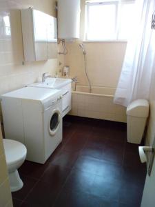 a bathroom with a washing machine and a sink at Apartment Palas in Banja Luka