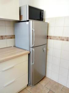 a refrigerator with a microwave on top of it in a kitchen at Apartment Palas in Banja Luka