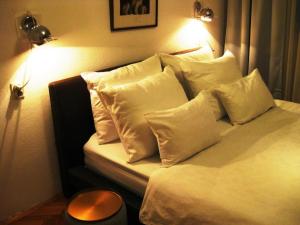 a bed with white pillows on it in a room at Apartment Palas in Banja Luka