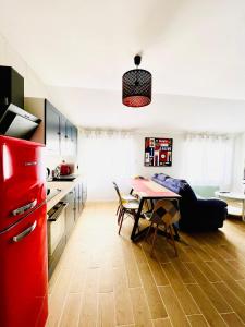 a kitchen with a red refrigerator and a table at Merveilleux T2 en hypercentre in Châlons-en-Champagne