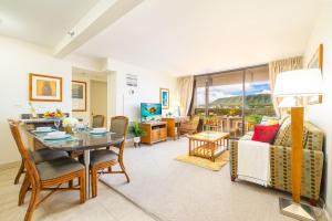 a living room with a table and a dining room at Great Diamond Head Views, 2BR Condo with Free Parking! in Honolulu