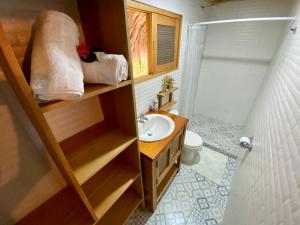 a small bathroom with a sink and a toilet at Finca Flor de Maria in El Zaino