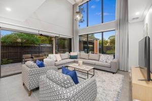 a large living room with couches and a tv at Villa Alessandro - Mornington Peninsula Luxury Accommodation in Tootgarook