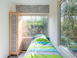 a window in a room with a bed next to a window at Beautiful holiday home in Arendonk with garden in Arendonk