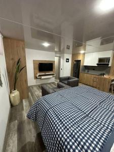 a bedroom with a blue and white checkered bed at Aparta estudio moderno in Envigado