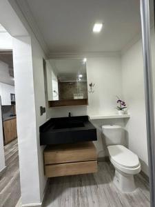 a bathroom with a black sink and a toilet at Aparta estudio moderno in Envigado