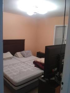 Кровать или кровати в номере AzulTDF C