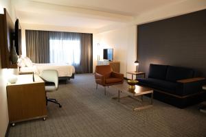 a hotel room with a bed and a couch at Courtyard by Marriott Philadelphia Springfield in Springfield