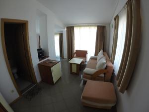 a living room with a couch and chairs and a window at Hotel Filland in Sozopol +53 photos