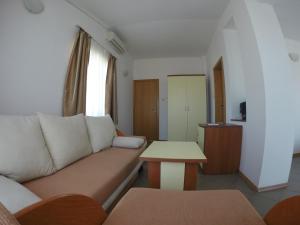 a living room with a couch and a table at Hotel Filland in Sozopol