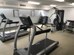 a gym with several tread machines and a treadmill at Great Diamond Head Views, 2BR Condo with Free Parking! in Honolulu