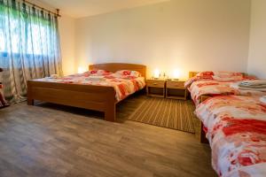 a bedroom with two beds and a window with two lamps at Holiday house with a parking space Sleme Skradsko, Gorski kotar - 20726 in Skrad