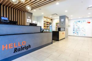 a hotel lobby with a helio raigitt counter at TownePlace Suites by Marriott Raleigh - University Area in Raleigh