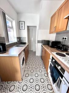 a kitchen with a washer and dryer in it at Homey 2 bedroom near the city in Gateshead