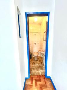 a hallway to a bathroom with a toilet and a sink at Casa charmosa no Centro Histórico com garagem in Ouro Preto