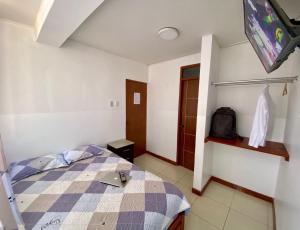 a bedroom with a bed and a tv in it at Hostal Venus - Nueva Imagen in Huacho