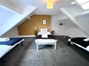 a bedroom with two beds in a attic at 4 bedroom home 10 mins to city in Gateshead