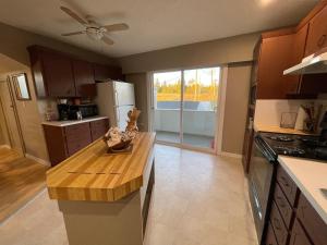 a kitchen with a wooden counter top in a room at 3-Bedroom Apartment in 108 Mile Ranch