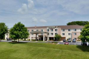 a hotel with a green lawn in front of it at Courtyard Danville in Danville